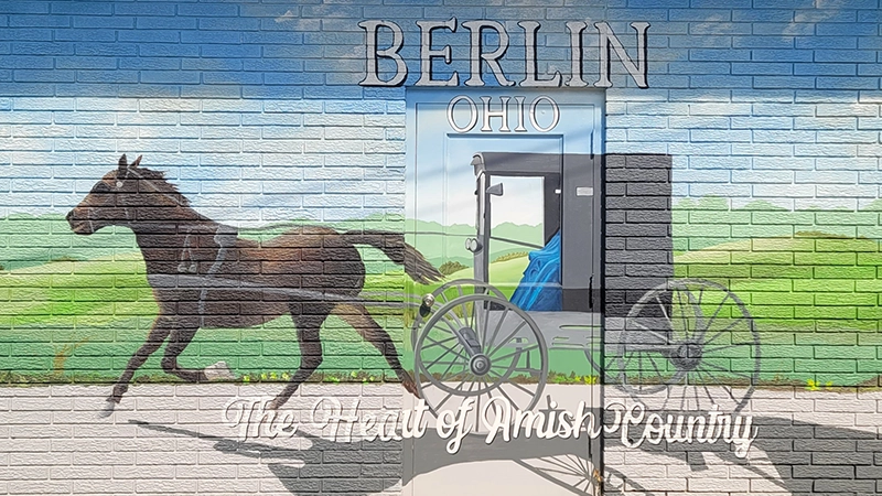 Mural of Amish Buggy on a brick wall.